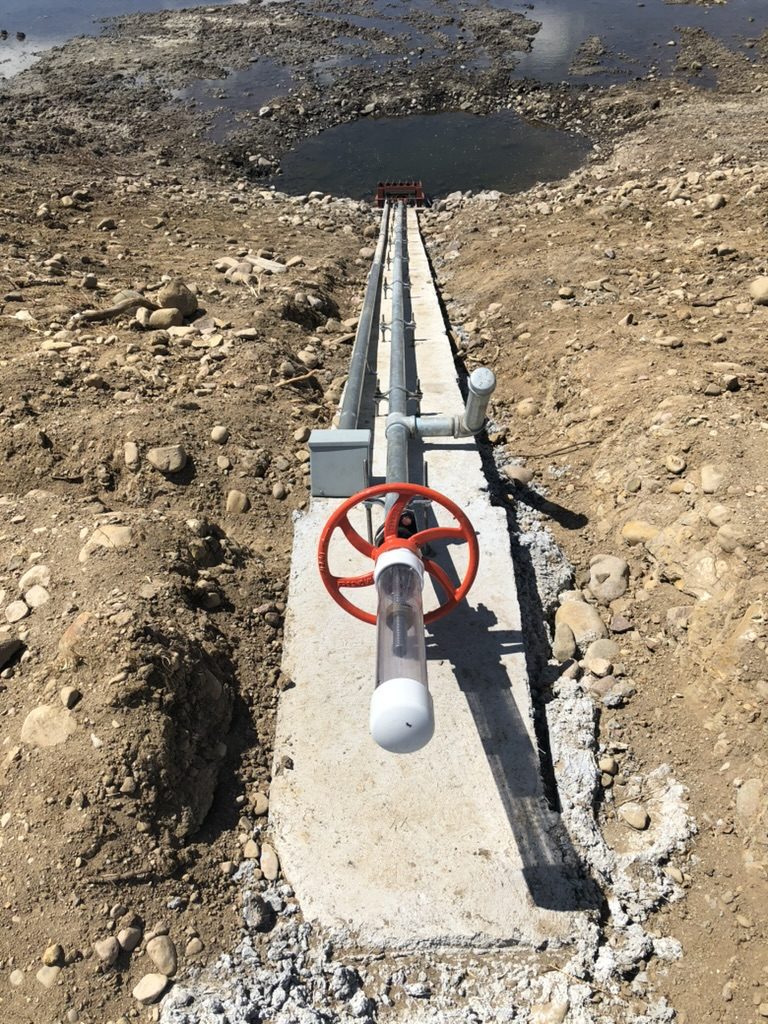 Diversion structure with a hand wheel and stilling well in a dewatered channel